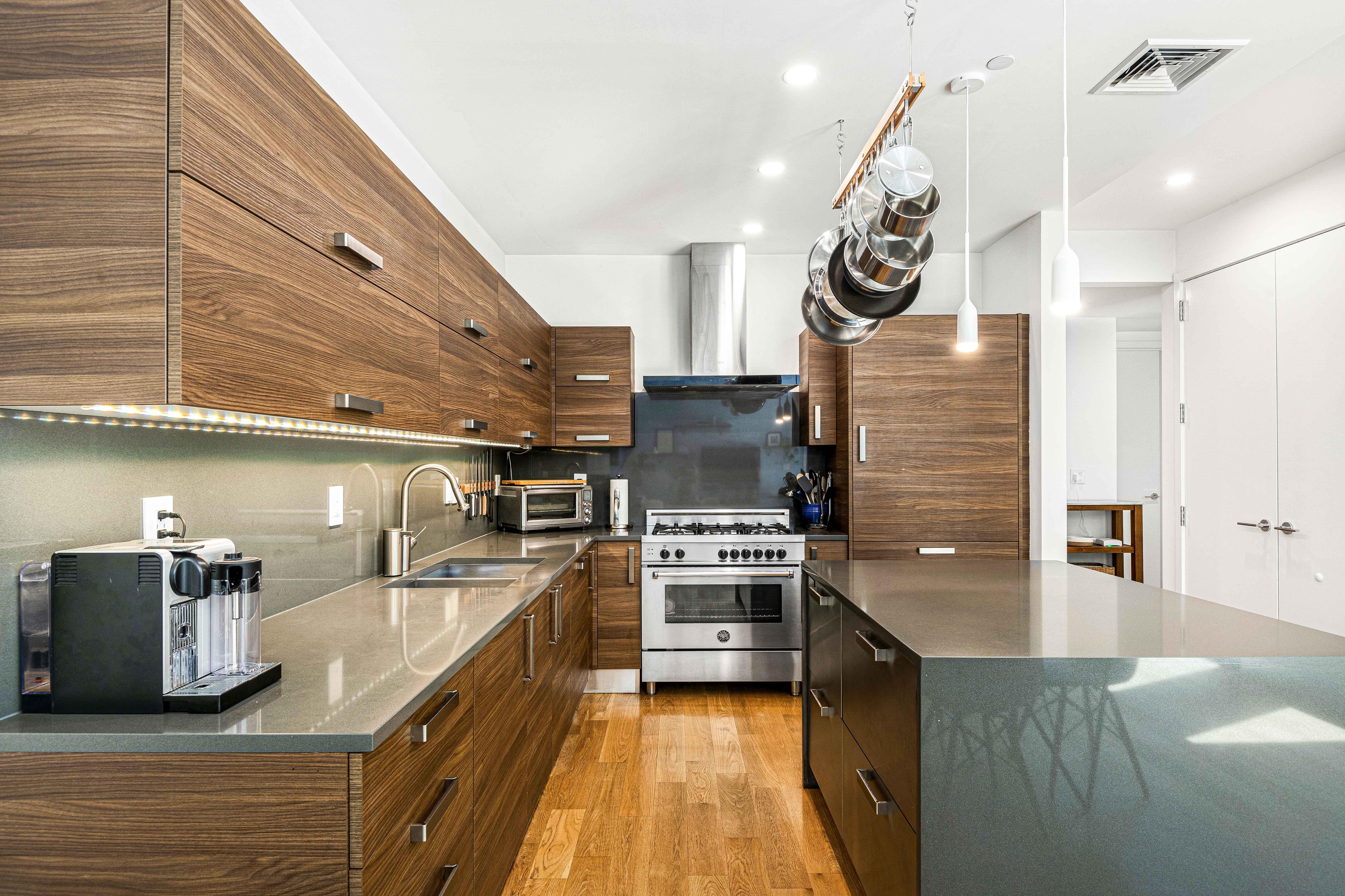 Kitchen of a luxury home for sale with an island and stainless steel appliances 