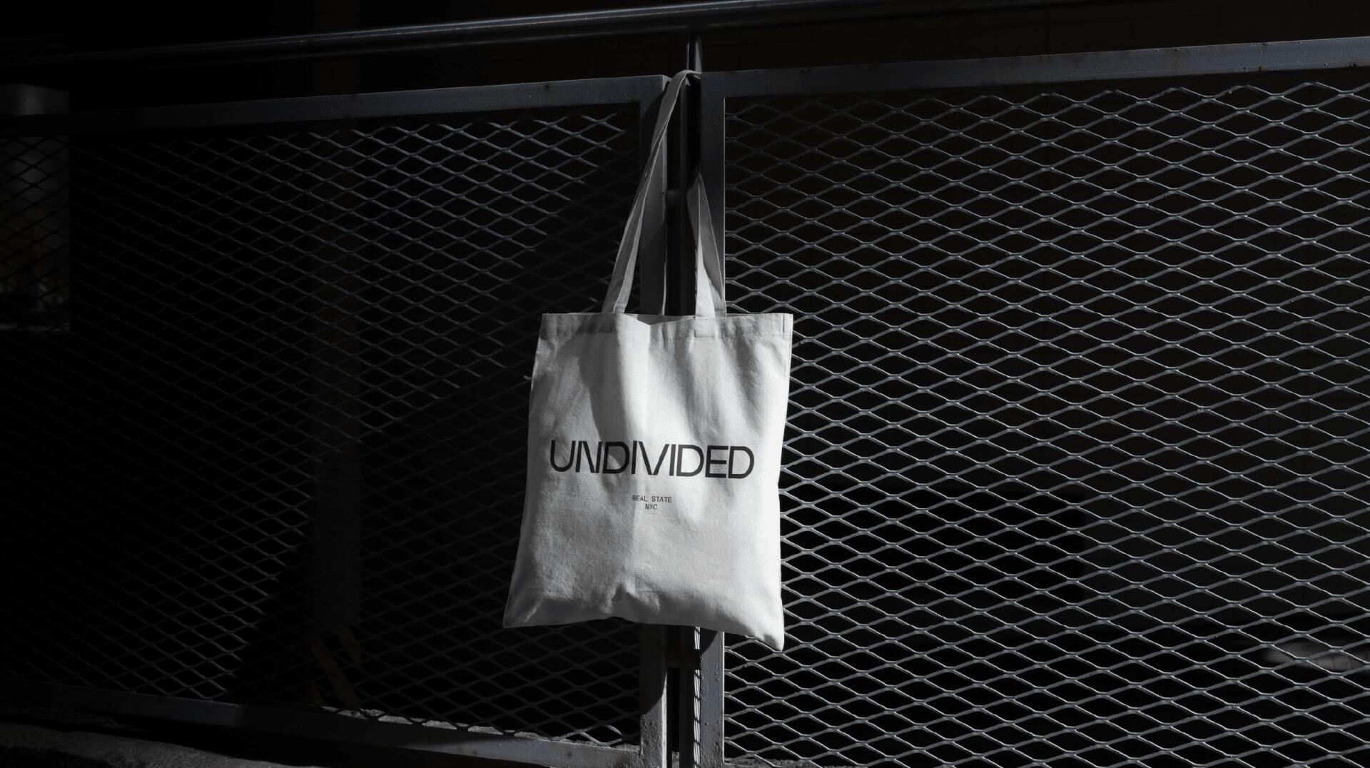 Undivided branded tote bag representing the company's commitment to modern, stylish real estate solutions in NYC.