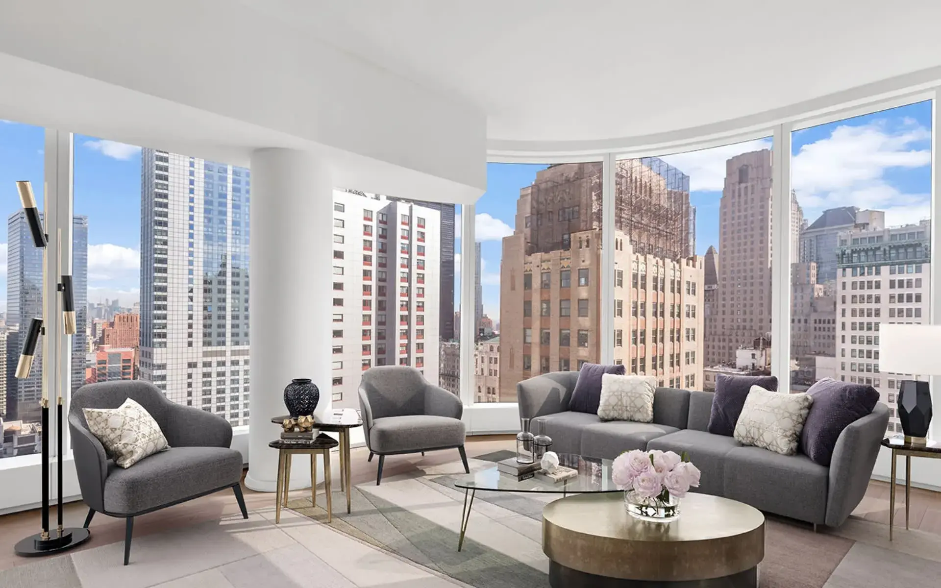 Elegant New York City apartment living room with curved panoramic windows.