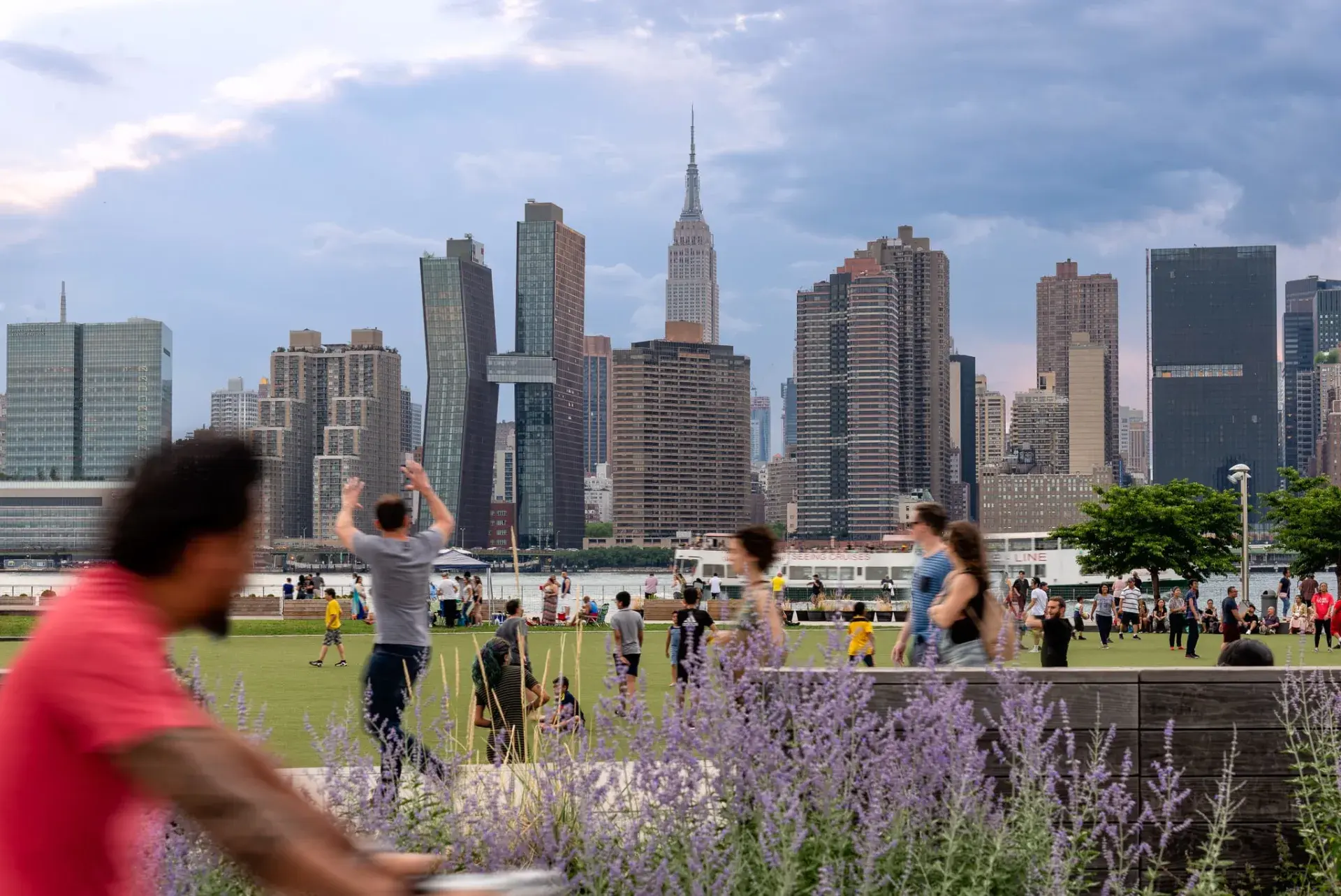 A vibrant public park with people enjoying the Empire State Building view.