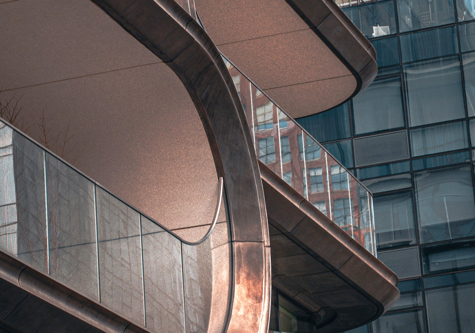 Close-up of futuristic curved metal and glass balcony on luxury high-rise.