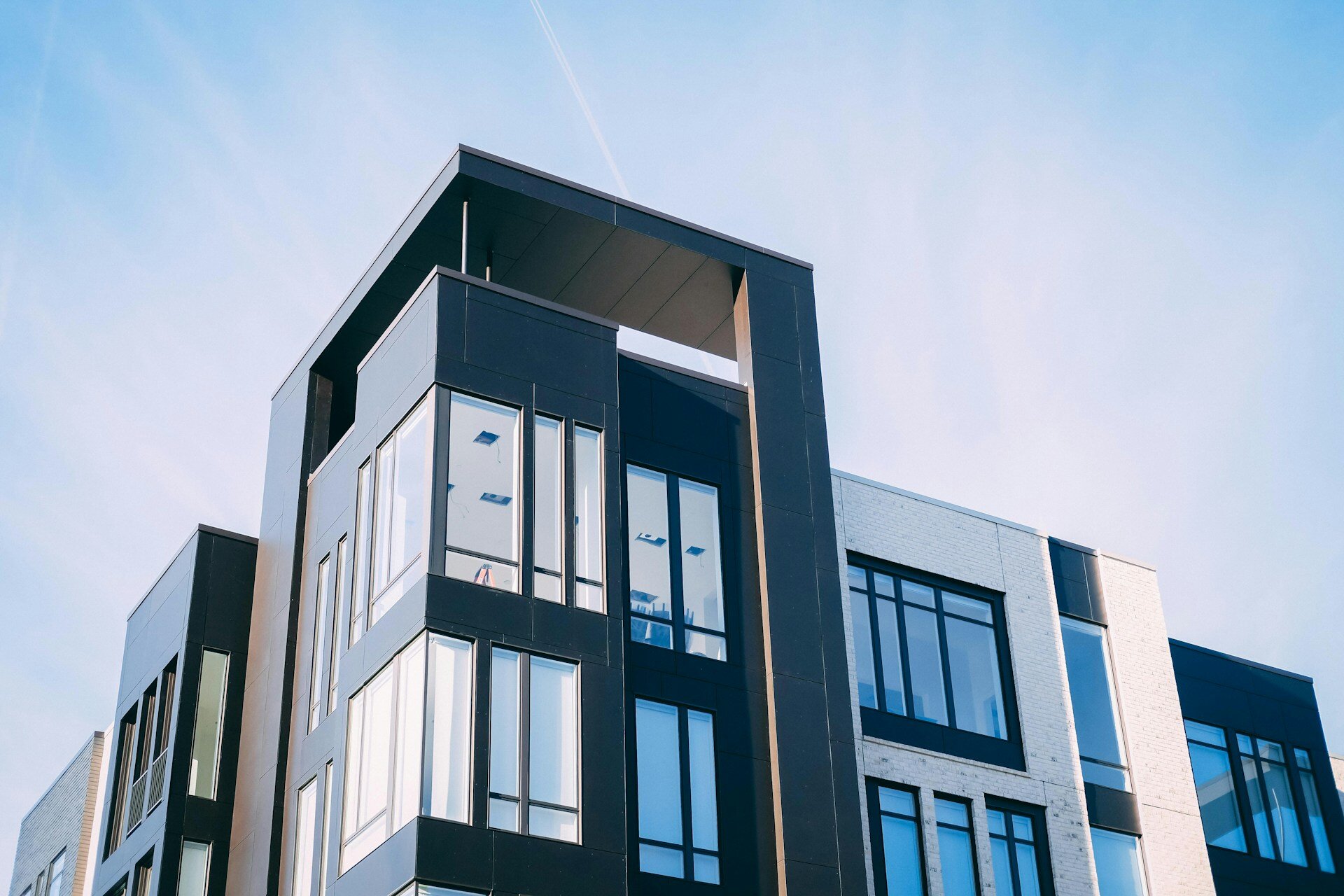 Contemporary apartment building with large glass windows and modern design.