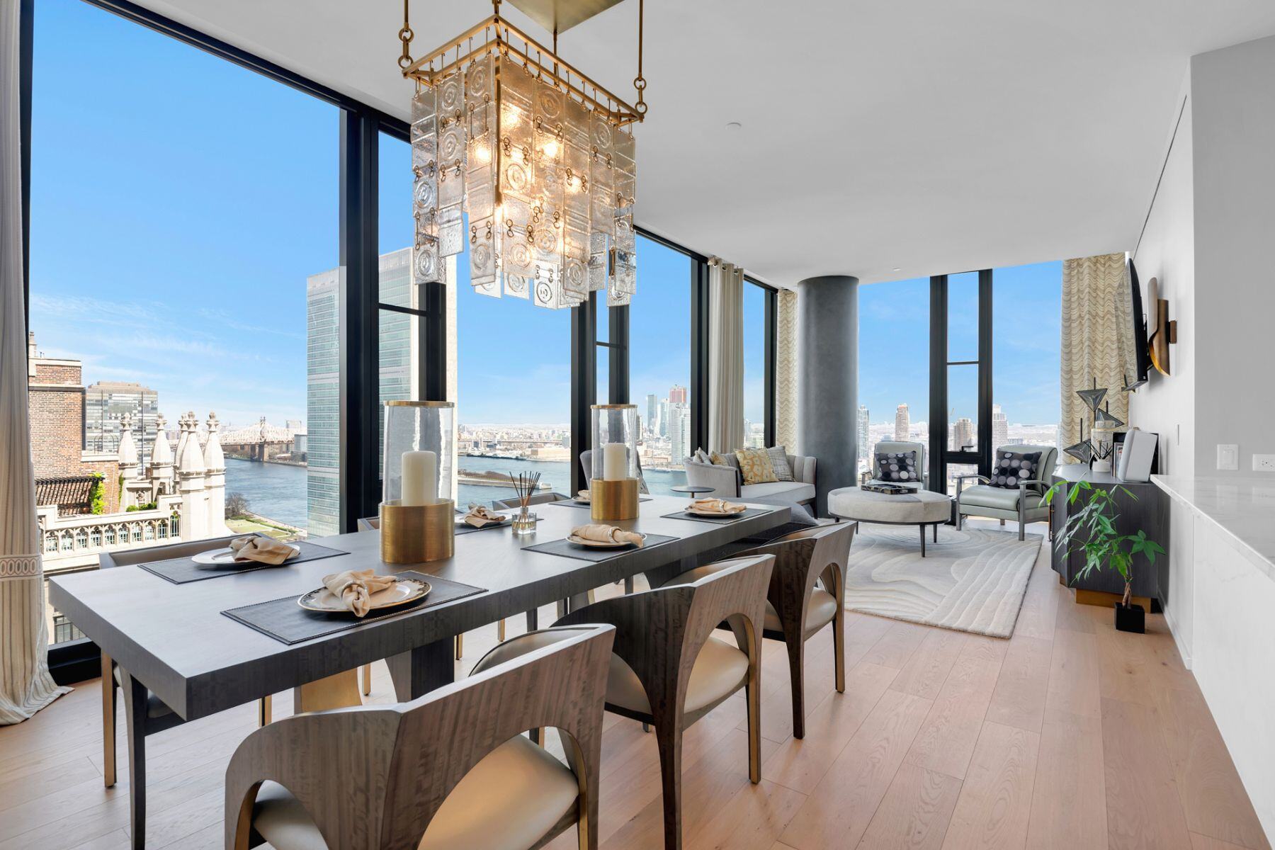 A luxurious dining room in a high-rise apartment, featuring panoramic views of New York City.