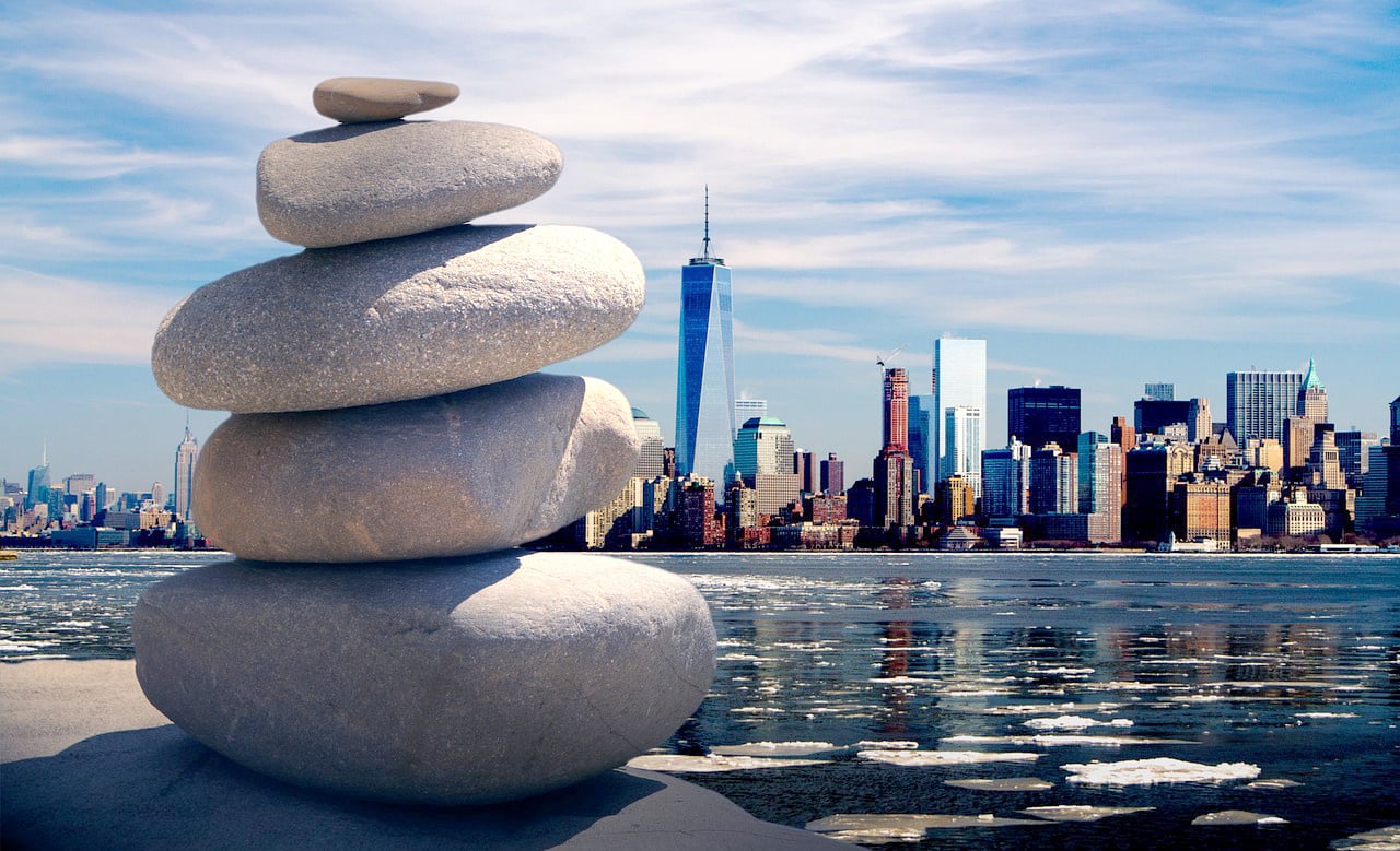 Zen stones and the city skyline representing good Feng Shui