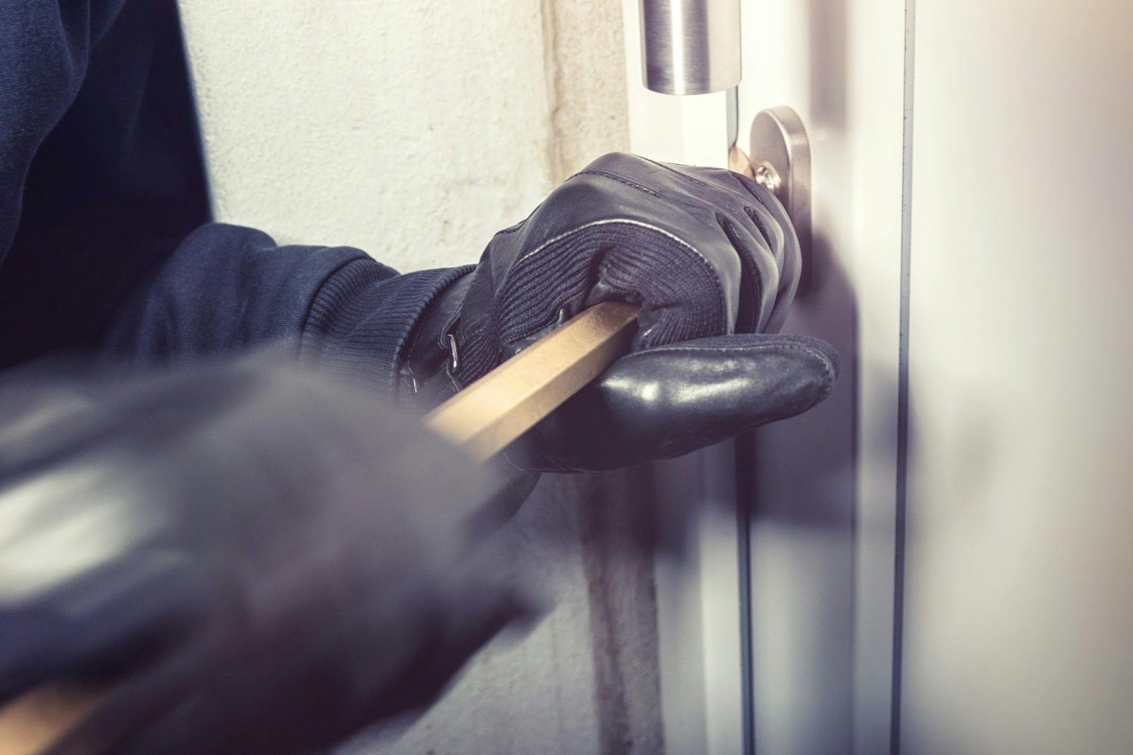 Burglar breaking into a ground floor apartment