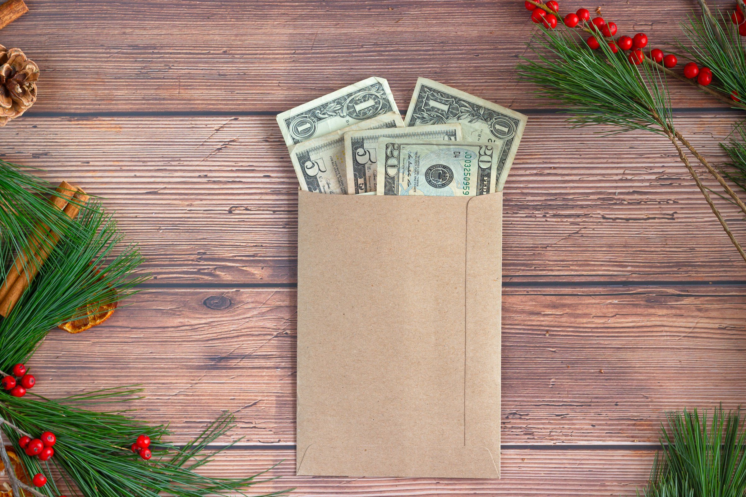 Cash in an envelope, representing real estate tipping during the holidays.